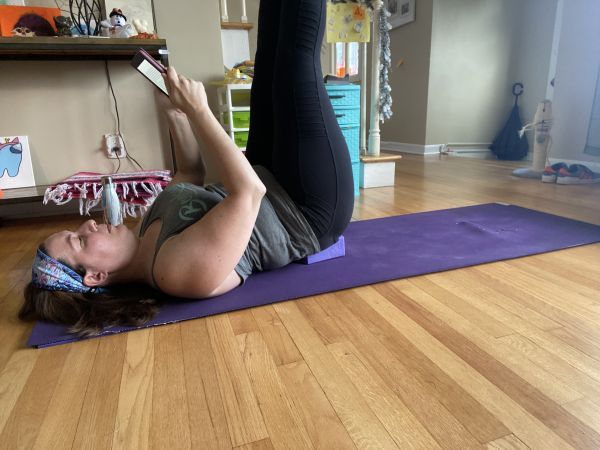 author reading while in supported shoulderstand