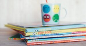 stack of picture books with a mug