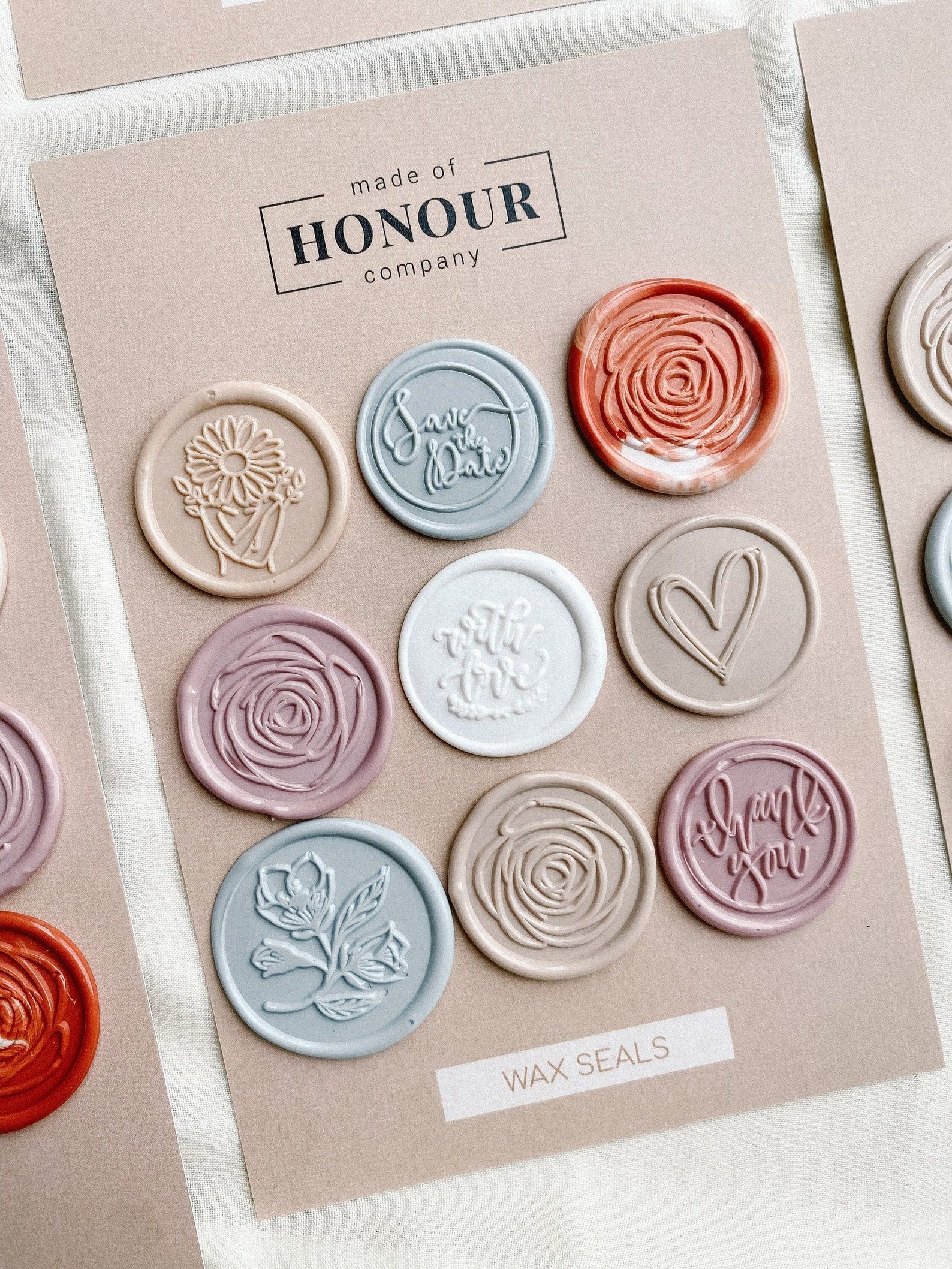 Image of a pack of wax seals with a variety of shapes and colors, including many types of flowers. 