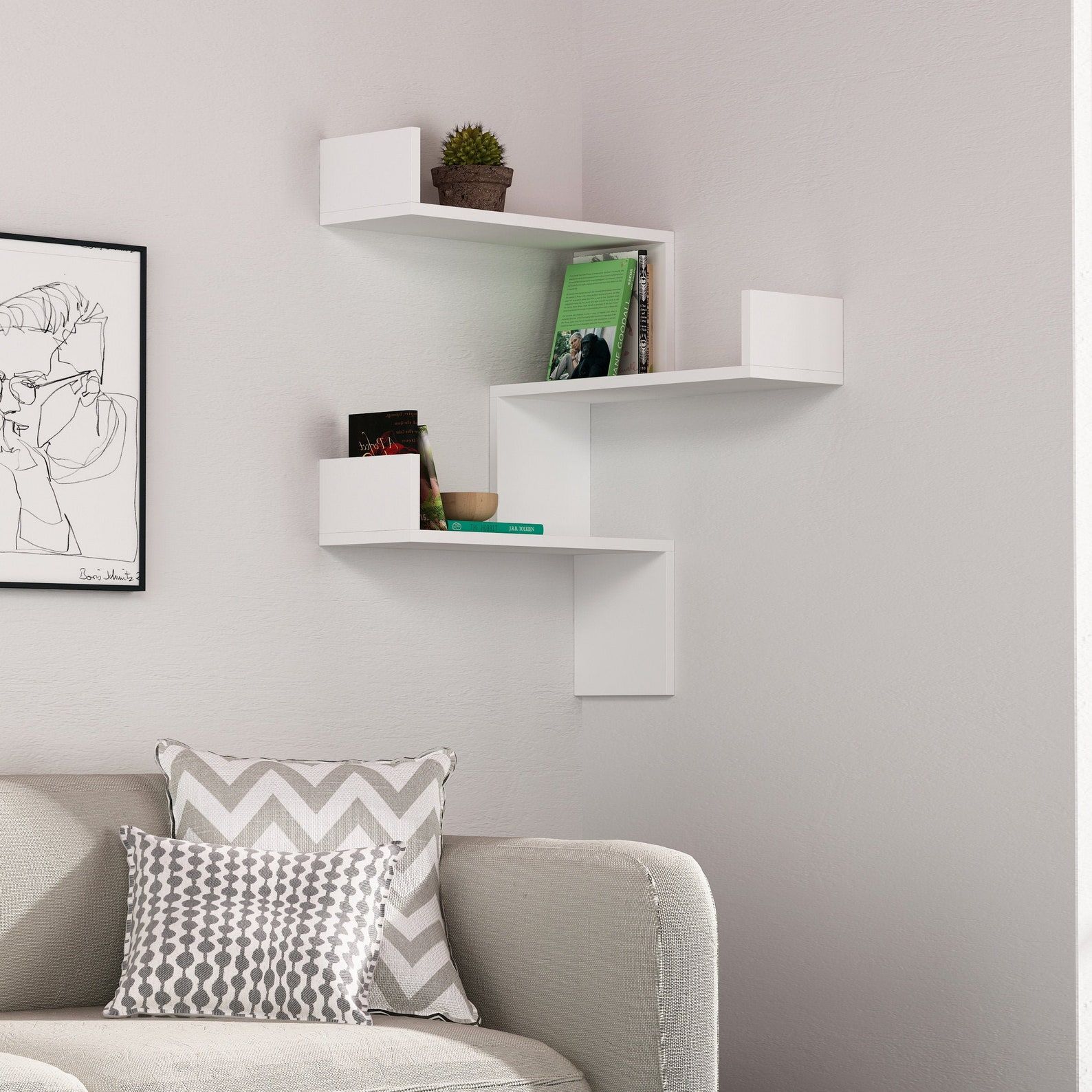 white corner wall bookcase with books shelved on the arms and a plant on the top shelf