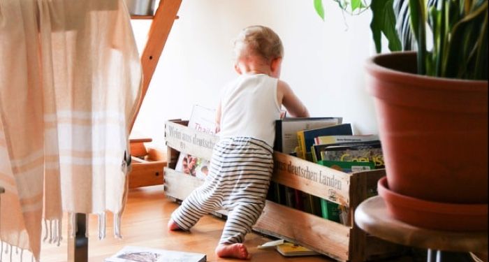 baby rummaging through books