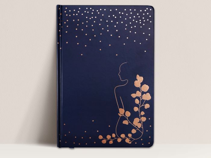 navy notebook with flowers and person profile