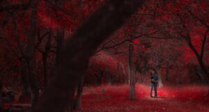 a couple kissing in a magical glowing red forest