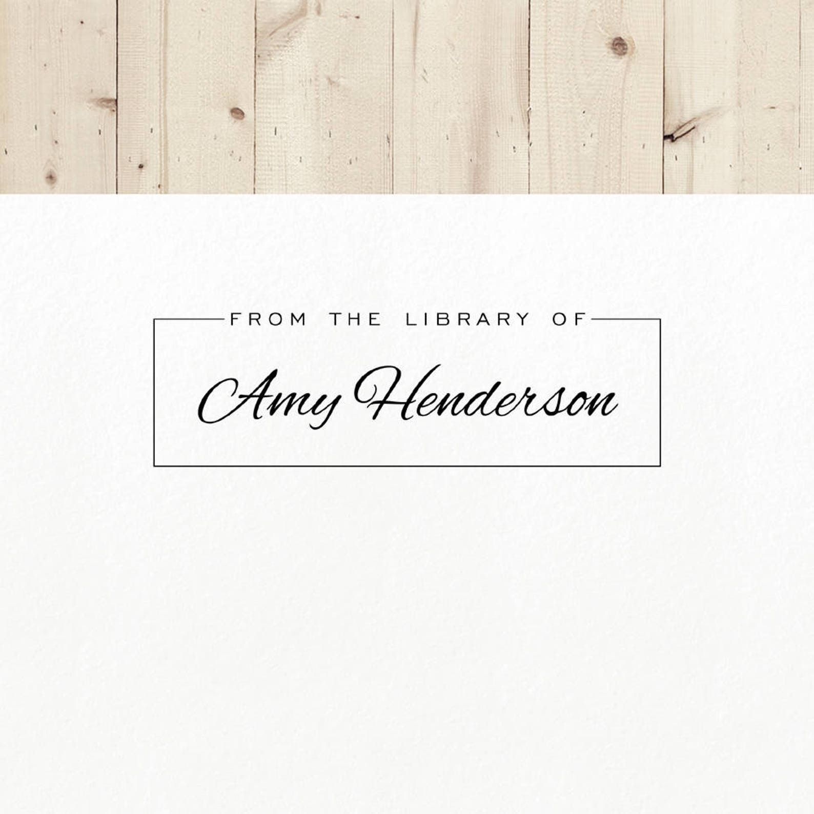 Image of a custom book stamp that reads "from the library of amy henderson." 