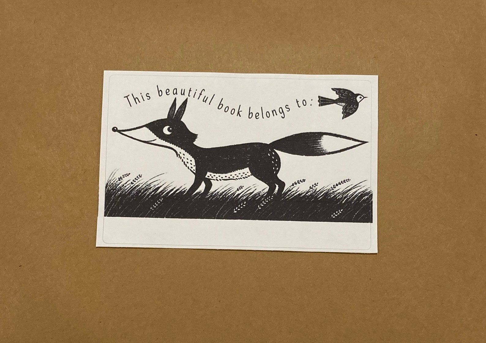 Image of a book plate. The plate has a fox and a bird on it, and the text reads "this beautiful book belongs to." 