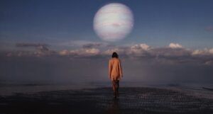 surreal image of young woman walking across water towards a planet in the distance