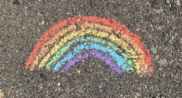 image of a chalk rainbow on concete