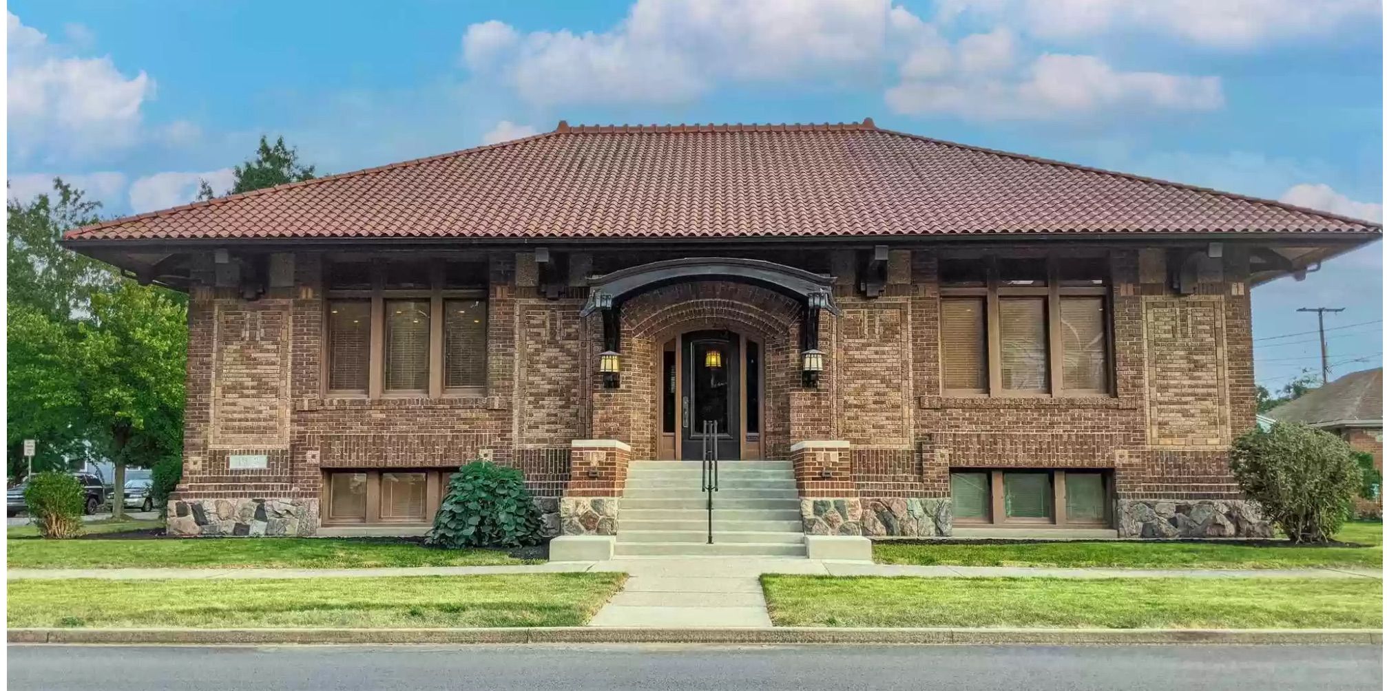 Image of a brown and orange brick library. 