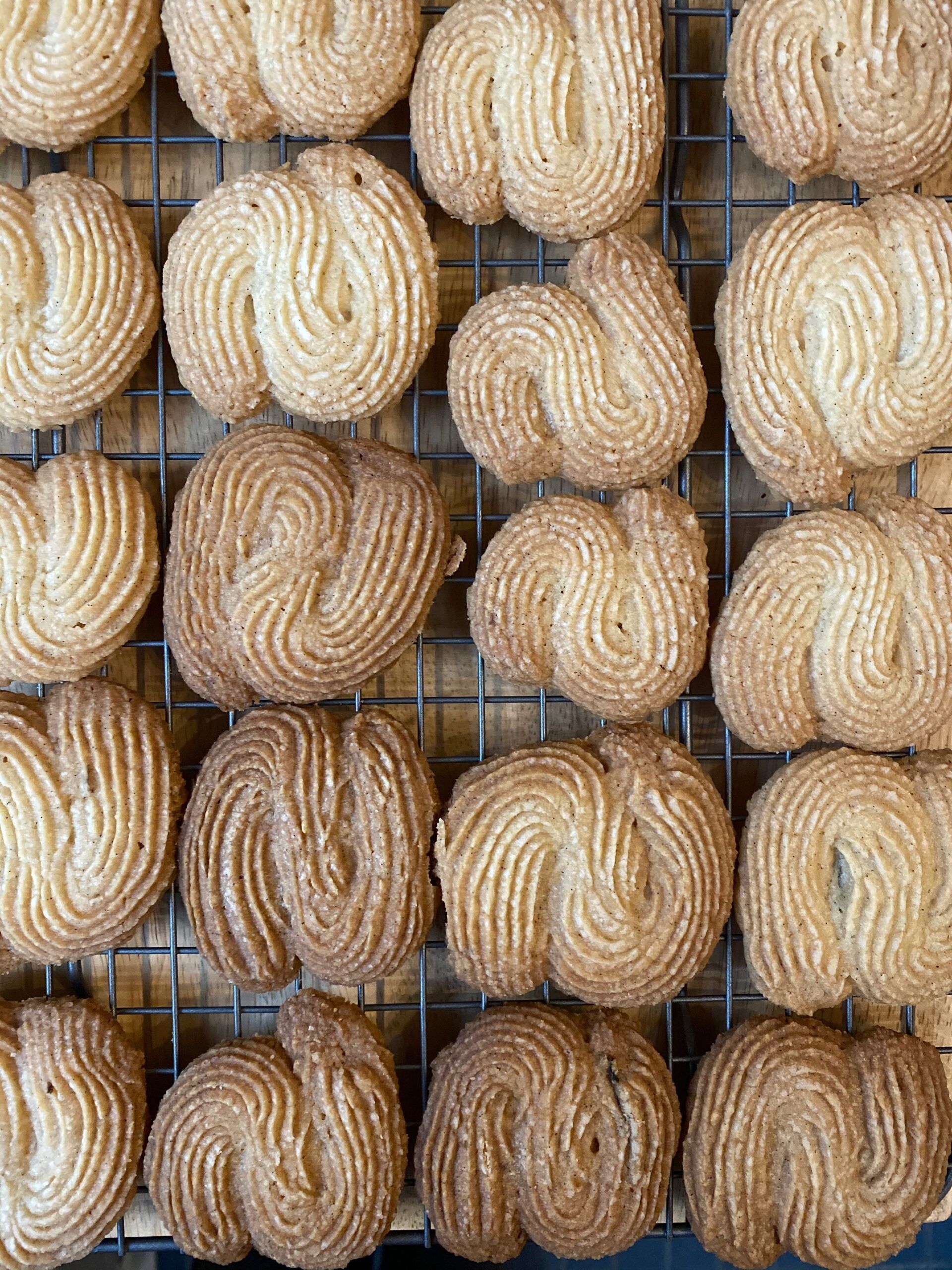 Rows of buttery, S-shaped cookies, with little golden brown ridges along their tops.