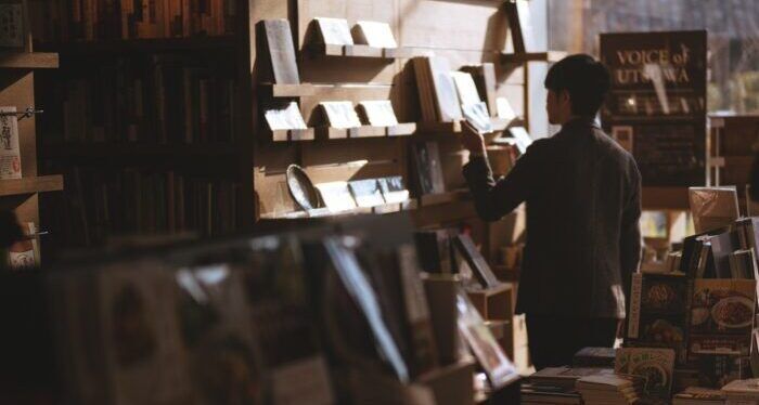 Man in a Tokyo bookstore finding books