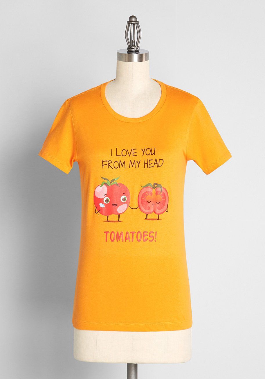 Image of a bright yellow shirt. In the center are two red tomatoes with the words "I love you from my head tomatoes!." 