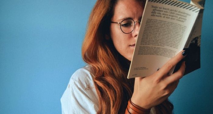 woman reading blue background