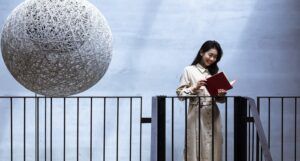 Asian woman reading on stairs