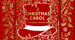 cropped red and gold cover of A Christmas Carol with a top hat and gold filagree