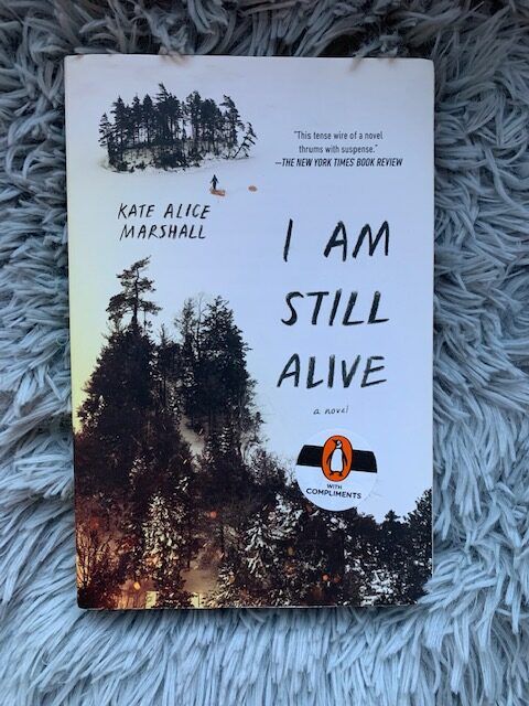 Cover for I Am Still Alive book on a gray background.