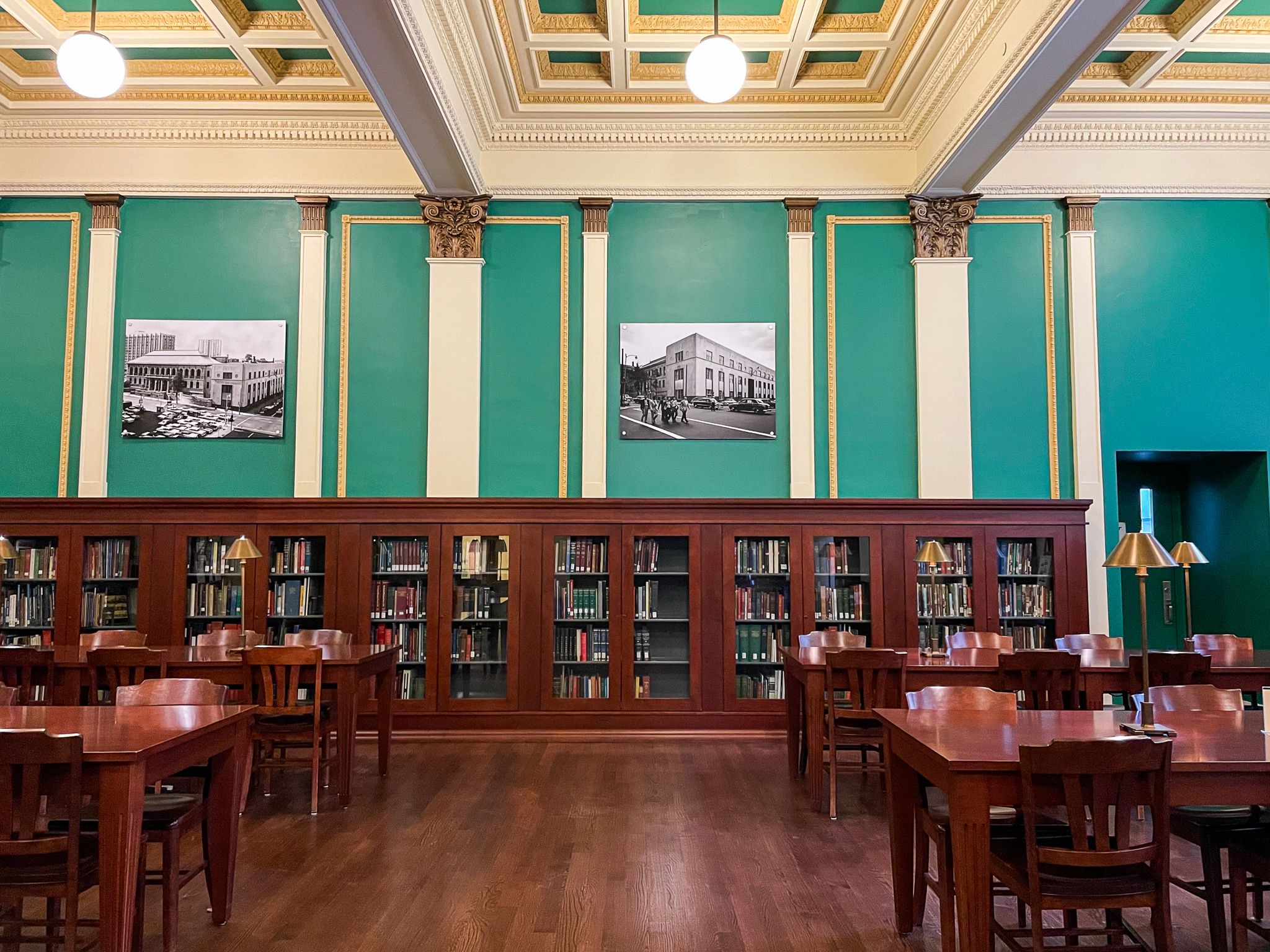 a photo of The Providence Journal Reading Room at the Providence Public Library , showing matching dark wood tables, chairs, and shelves