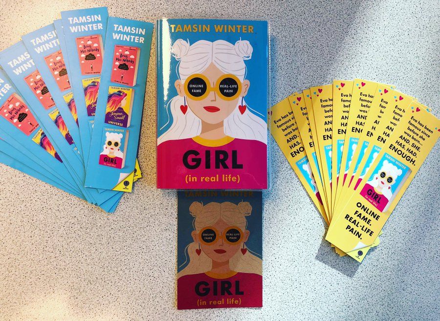 a photo of Girl (In Real Life) by Tamsin Winter with matching bookmarks displayed beside it