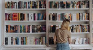 image of a white skin person at a book shelf