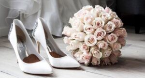 image of white heels and a pink bouquet