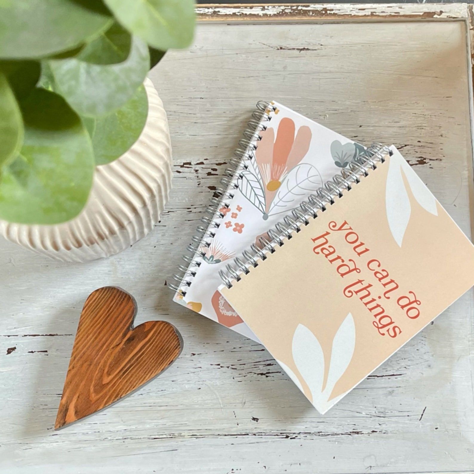 image of two notebooks on a white background. the top notebook reads "you can do hard things" on a light orange background. 