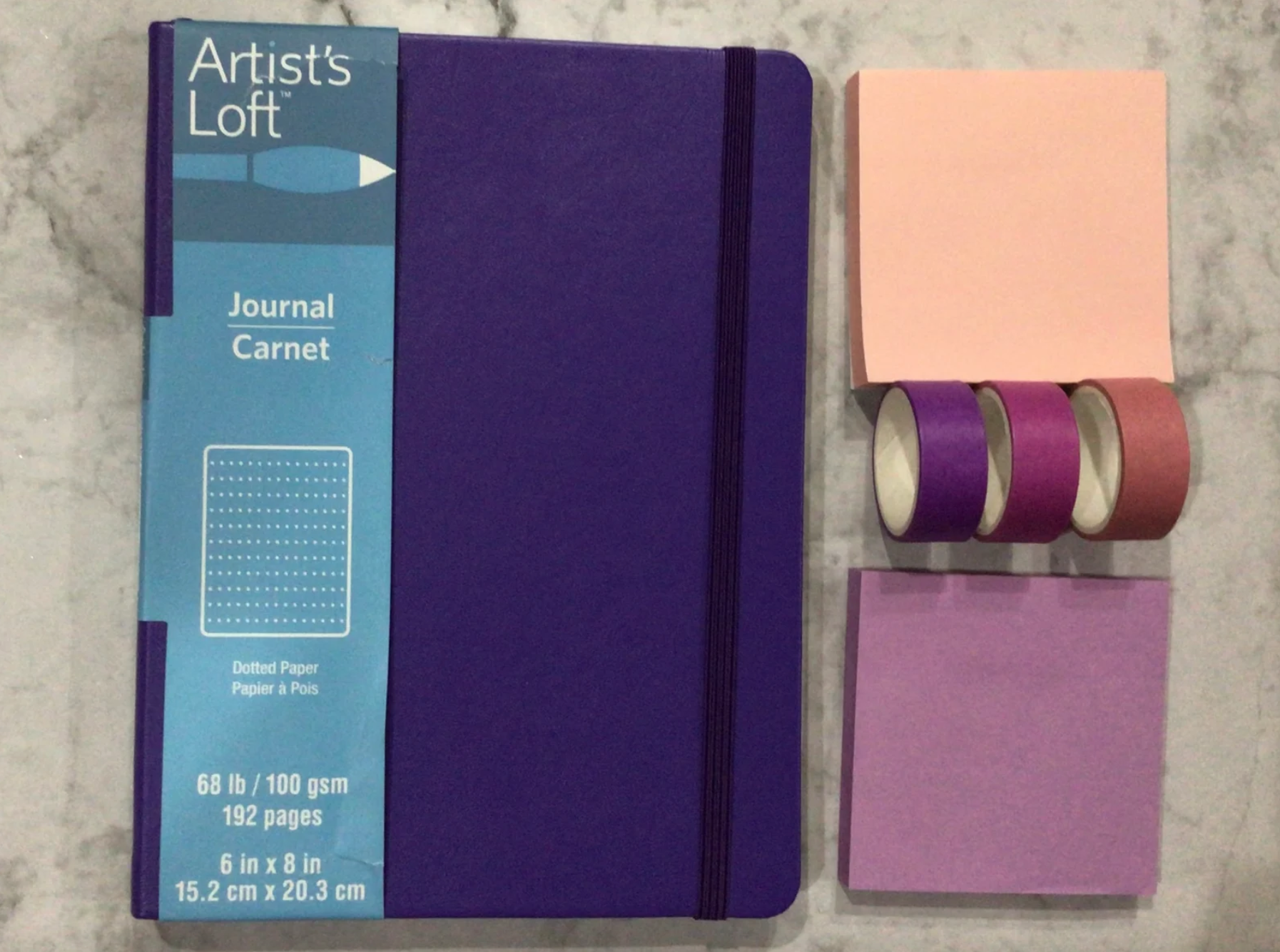 Purple bullet journal starter pack with journal, washi tape, and sticky notes