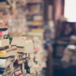 a photograph of a used bookstore piled high with book stacks