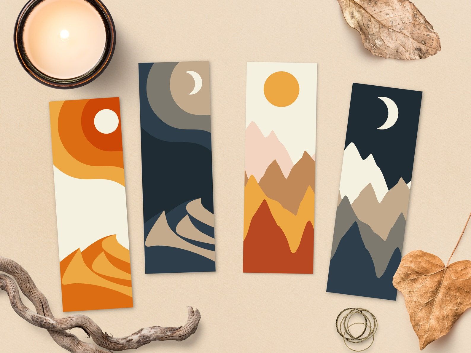 Four bookmarks, each featuring reds and oranges or blues and browns, alongside a sun, moon, and mountains and deserts. 