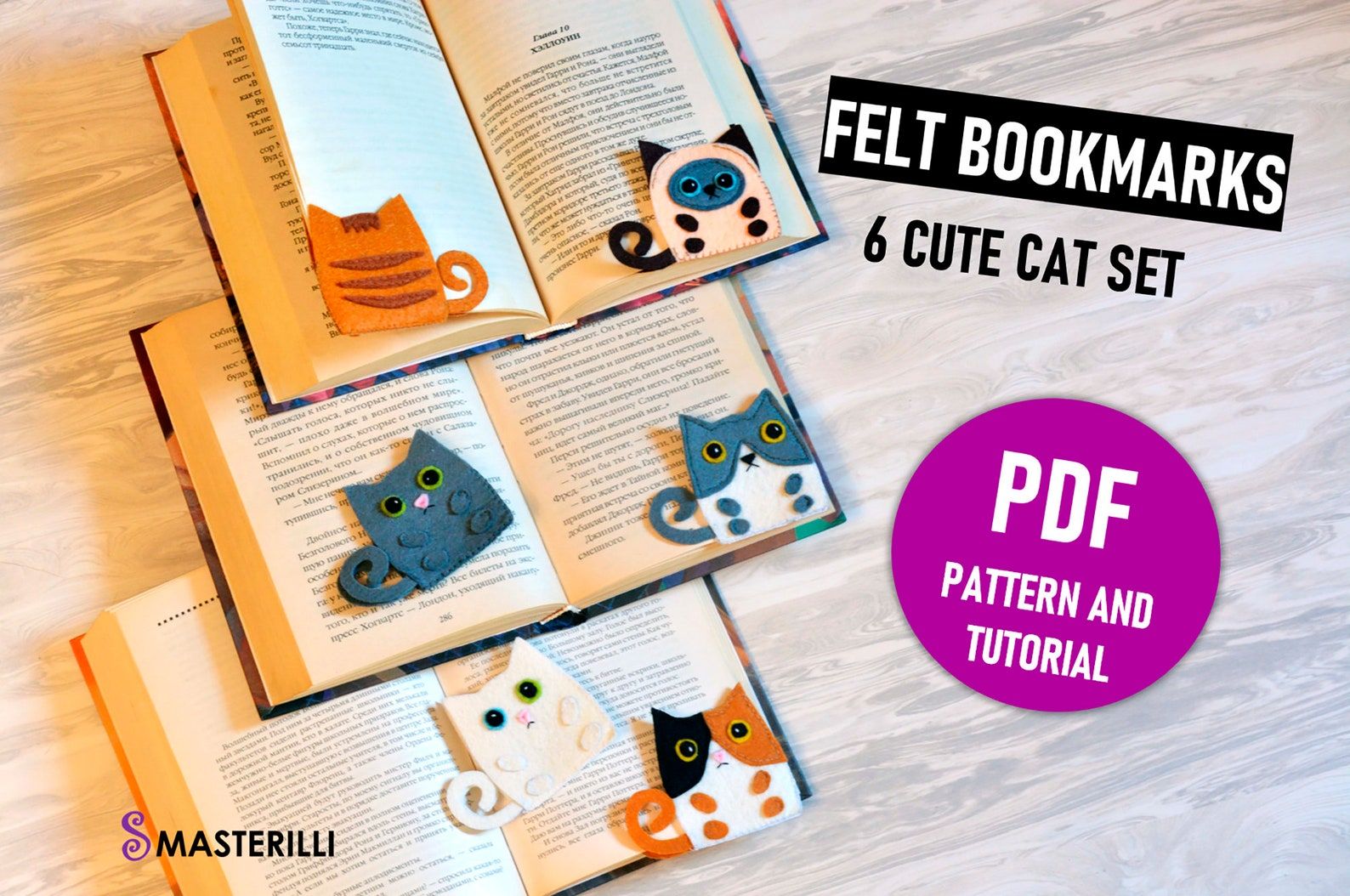 Image of three open books. There are six felt cat corner bookmarks on the books. 