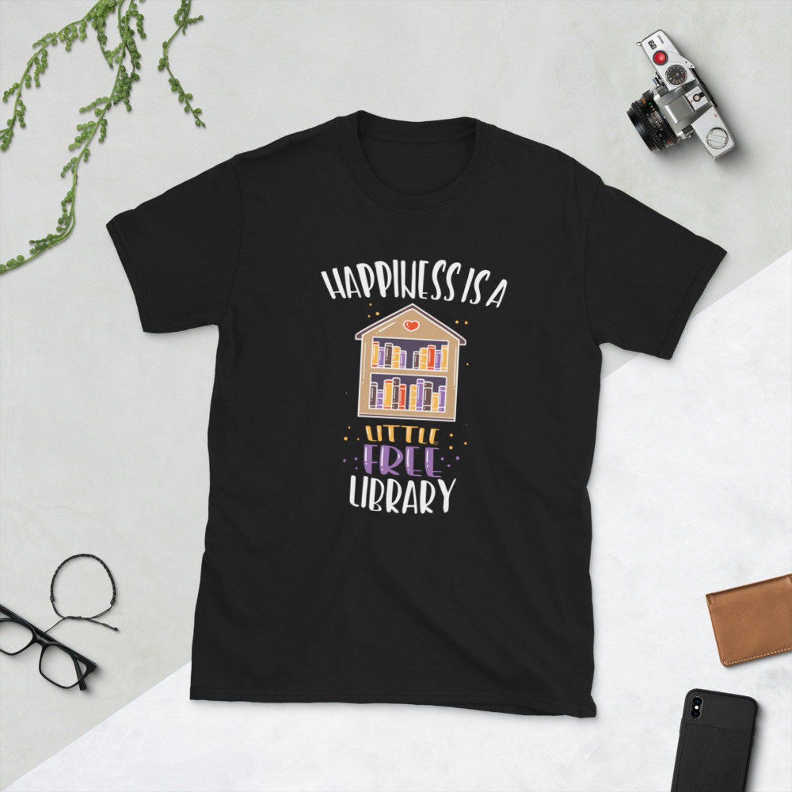 A black t-shirt with a LFL and the text "Happiness is a Little Free Library"