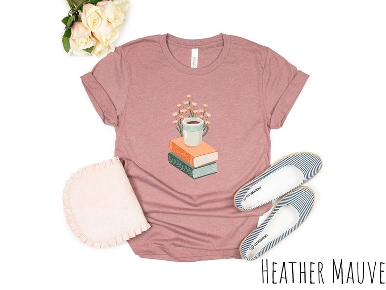 Pink t-shirt with a stack of books and a cup of coffee