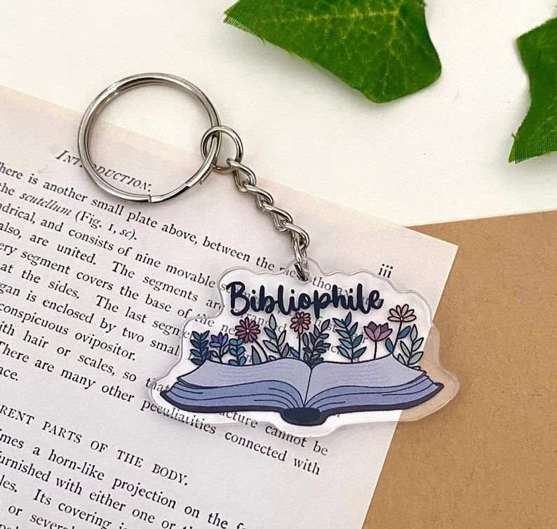 Keychain with book and flowers, says Bibliophile