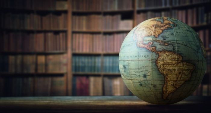 image of a globe in front of bookshelves