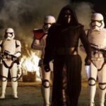 Adam Driver as Kylo Ren flanked by threee Stormtroopers in a still frame from Star Wars Episode VII: The Force Awakens