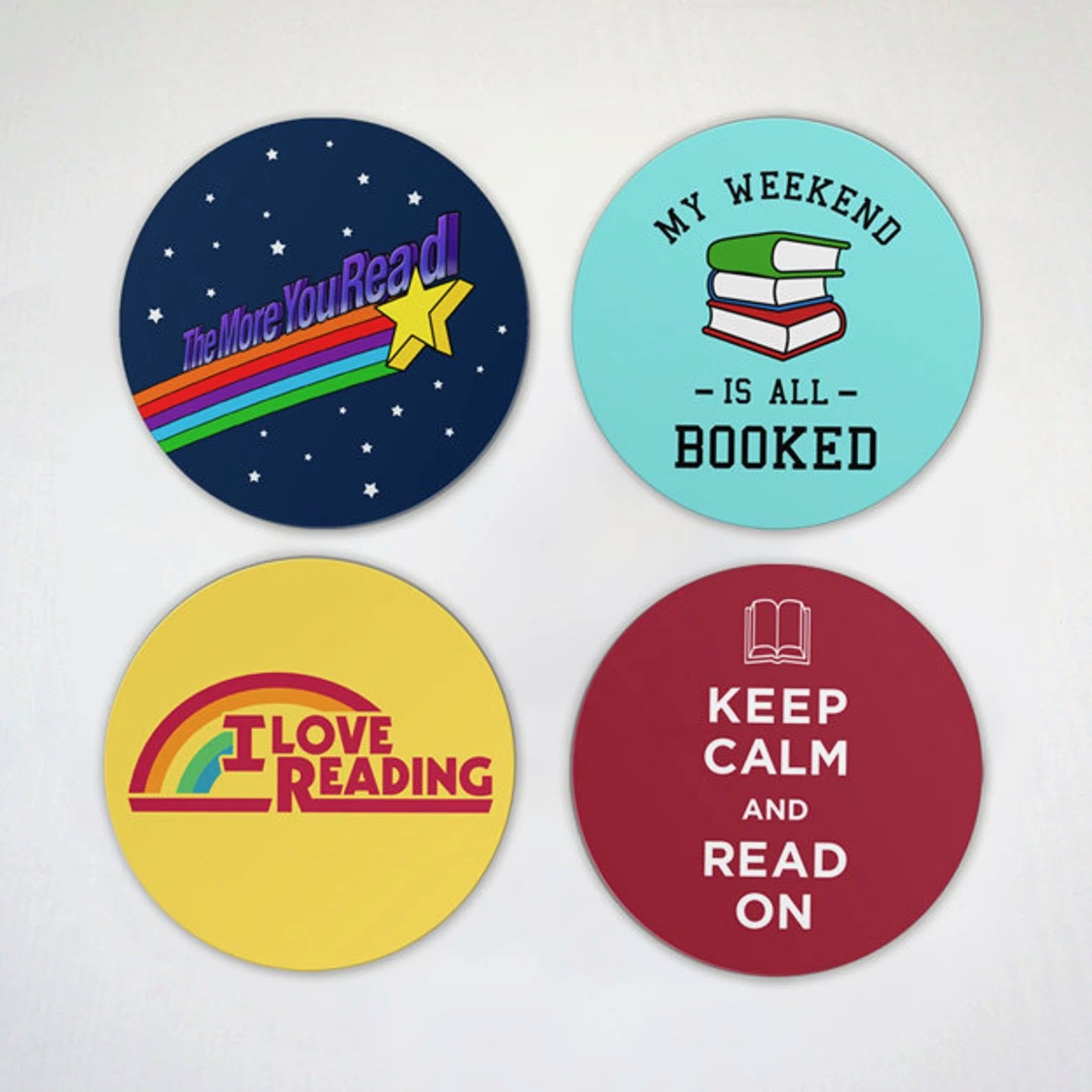 Four circular magnets in different colors, each with a different slogan: I Love Reading, Keep Calm and Read On, My Weekend is All Booked, and The More You Read.