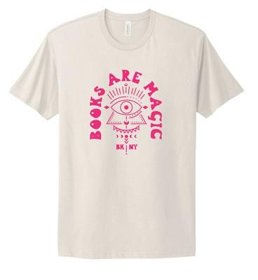 White t-shirt with pink text that reads "Books Are Magic" and an eye, triangle, and moons