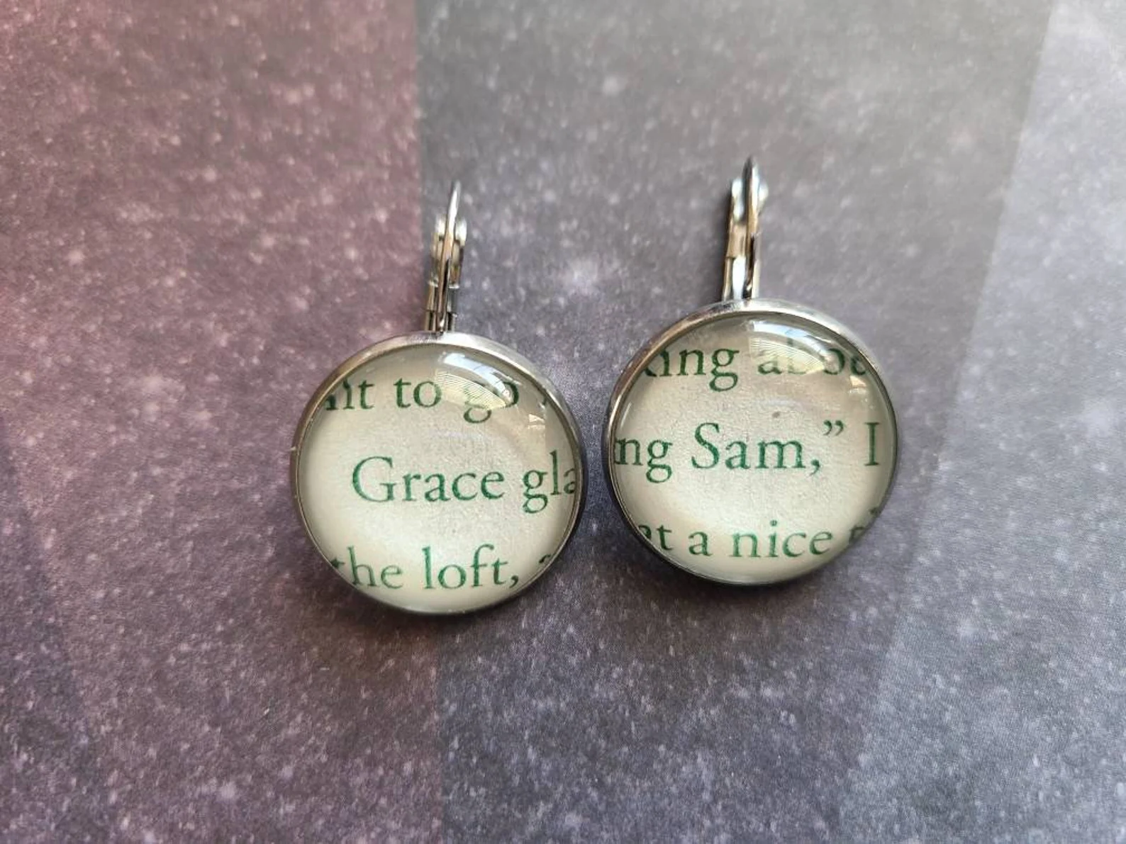 Two pendant earrings—one says grace, one says Sam—made from pages of the original book.