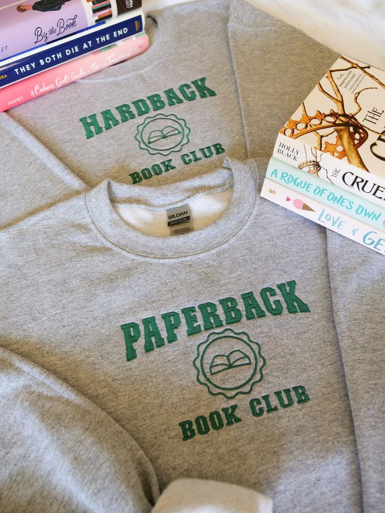 Two gray sweatshirts, each with green ink. One says "paperback book club" and the other says "hardback book club." 