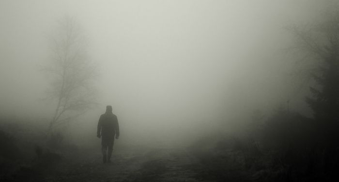 image of a person in black and white against a foggy background