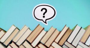 image of book spines with question mark above it