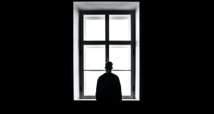 man standing in front of the window