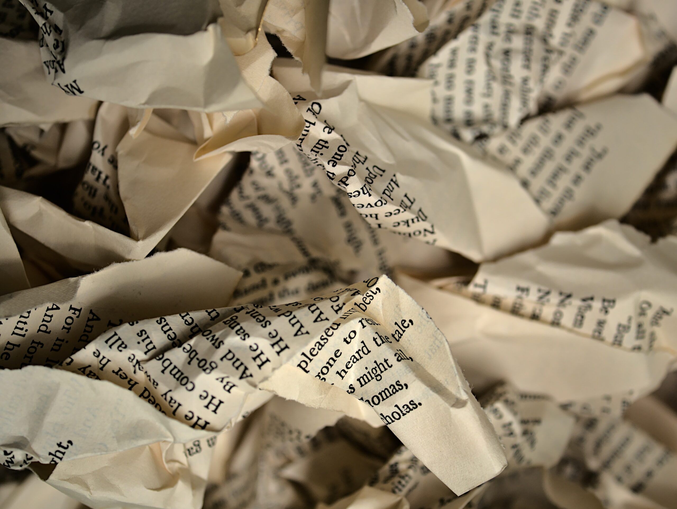 a photo of white and black printed paper crumpled