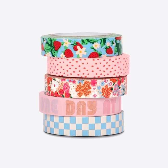 five rolls of washi tape in a stack, designs are in floral, pink and pastel colors