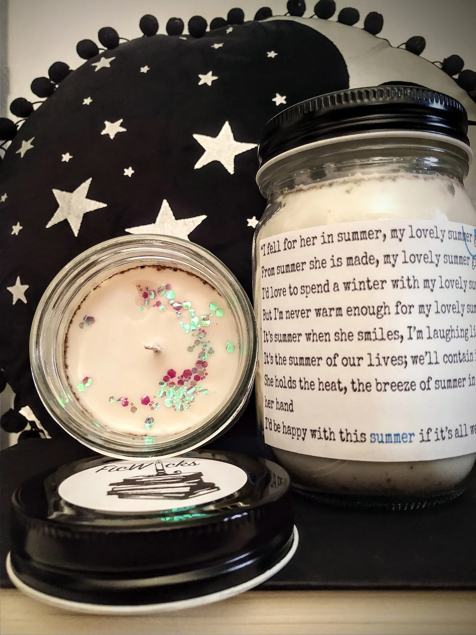 A white soy candle with a quote from Shiver about Sam falling in love with Grace