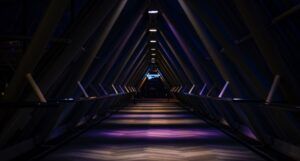 blue and purple light in a triangular tunnel