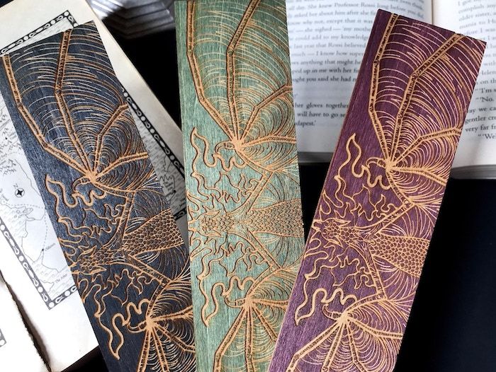 Etsy: Wooden bookmarks with dragons on them in blue, green, and red.