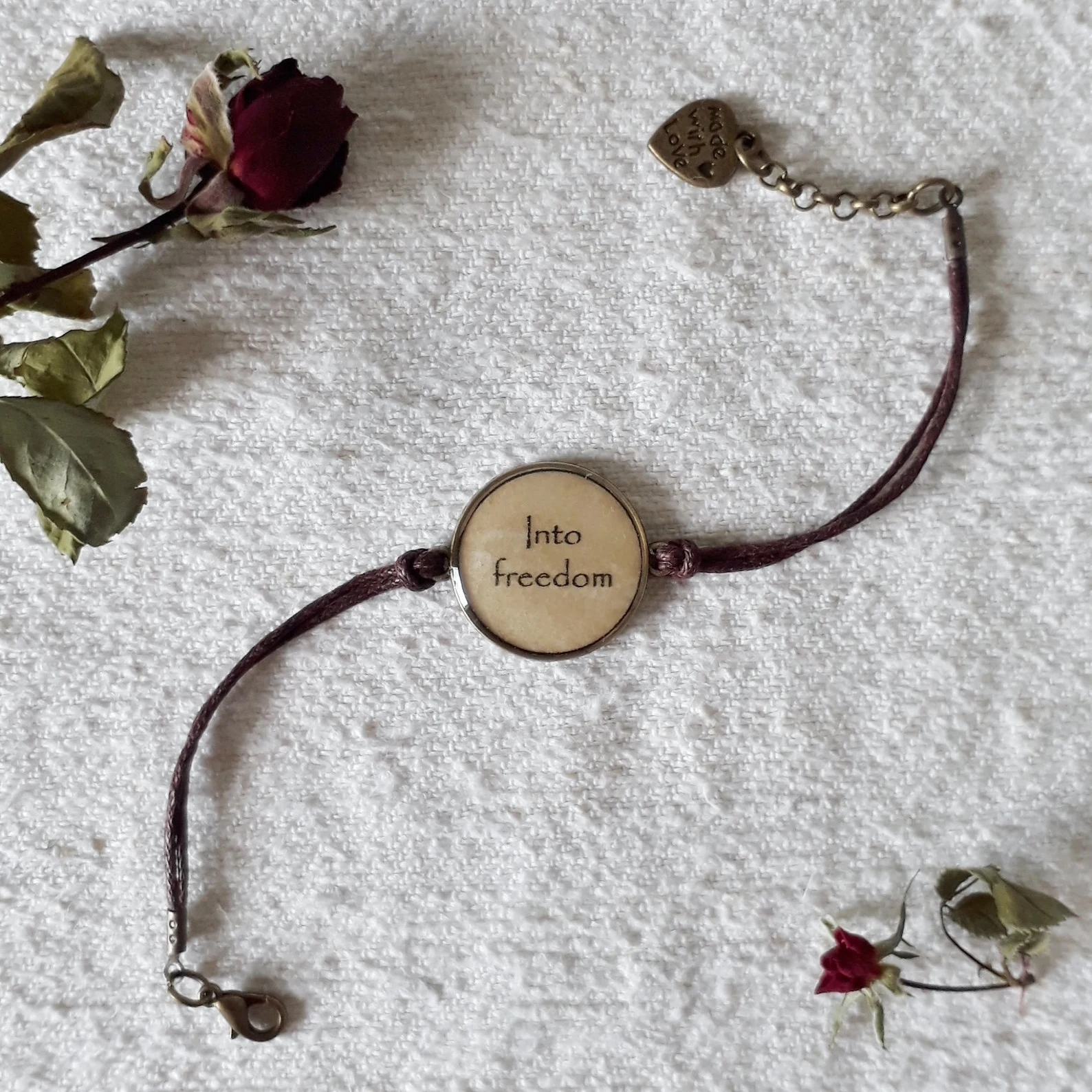 A bracelet with a pendant that reads "into freedom"