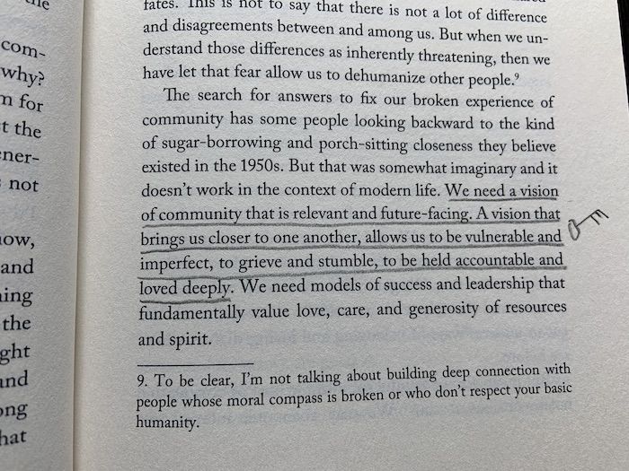 text in a book that has been underlined: "We need a vision of community that is relevant and future-facing. A vision that brings us closer to one another, allows us to be vulnerable and imperfect, to grieve and stumble, to be held accountable and loved deeply." and a key drawn next to it