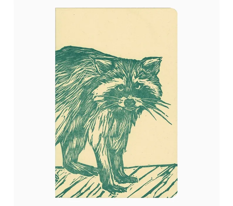 Image of a cream colored notebook with a green letter pressed raccoon on the cover. 