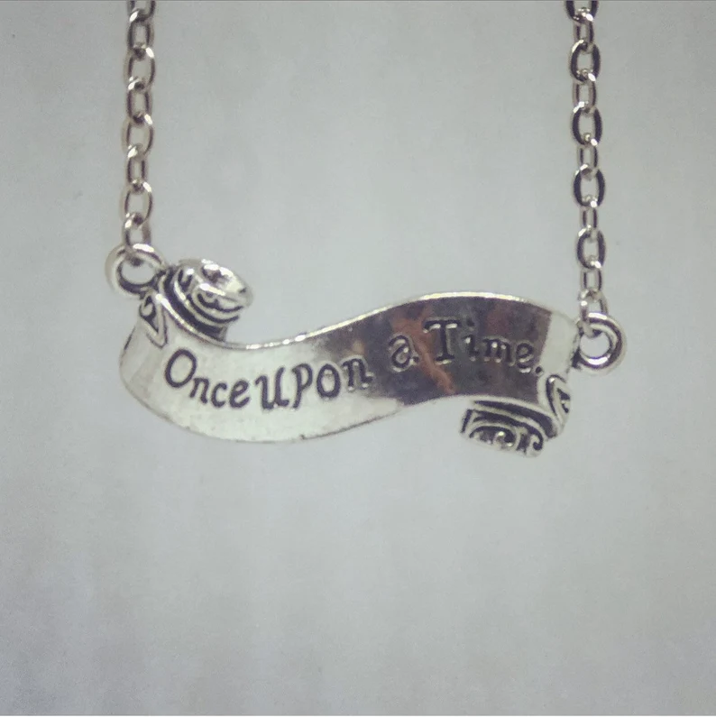 Image of a silver necklace. The pendant is a scroll which reads "Once Upon a Time."