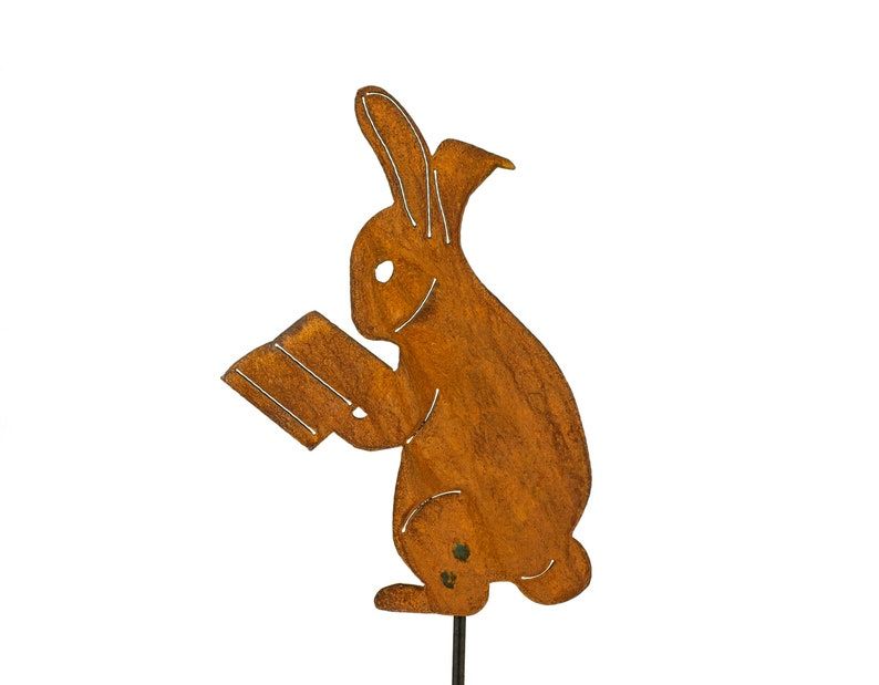 Image of a metal rabbit reading a book.